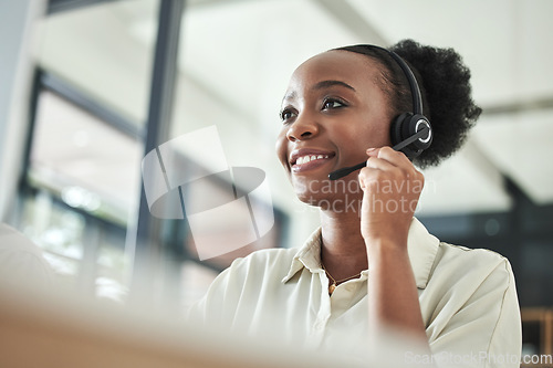 Image of Black woman, call center and phone consultation with a smile in a office with contact us work. Telemarketing, consulting job and African female employee with communication and customer service