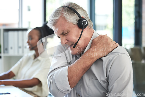 Image of Stress, callcenter and man with shoulder pain in customer service agency, senior manager with crisis. Communication, management with injury or fatigue, help desk consultant with problem on phone call