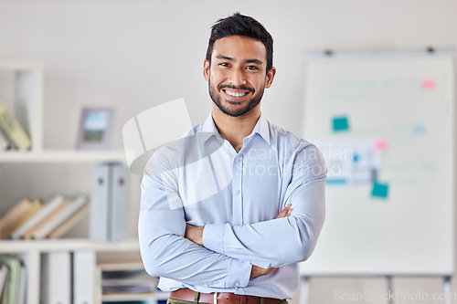 Image of Smile, education and portrait of man teacher in a classroom or school and happy to study in a college or university. Academy, educator and young person or worker arms crossed and confident in class