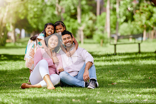 Image of Portrait, hug and asian family at a park happy, bonding and having fun outdoor together. Smile, love and children with parents on grass ground, embrace and relax while enjoying nature on the weekend