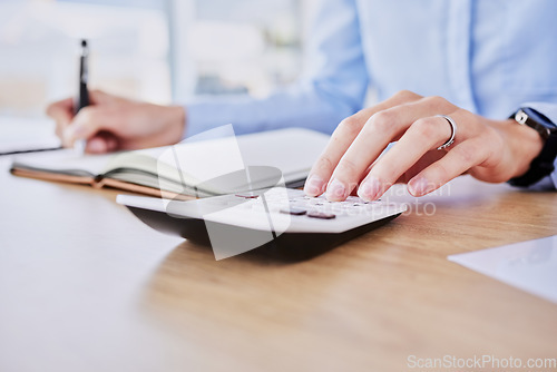 Image of Hands, typing and calculator in office closeup for audit, tax or bookkeeping for compliance, budget or planning. Accounting person, writing and notebook for banking, profit or financial data at desk