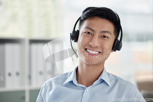 Image of Asian man, call center and portrait smile with headphones in customer service, telemarketing or support at office. Face of happy male person or consultant agent smiling for online advice at workplace