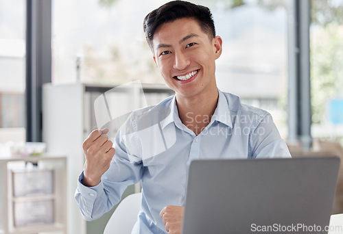 Image of Happy asian man, laptop and fist in celebration for winning, bonus or promotion at the office desk. Portrait of excited businessman by computer for good news, victory win or success at the workplace