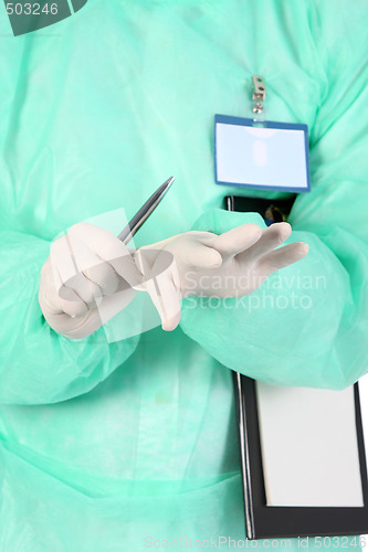 Image of surgeon putting medical gloves on
