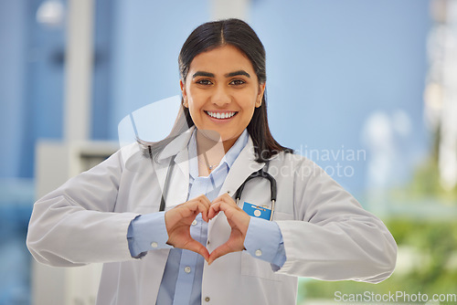 Image of Doctor, heart hands and portrait of woman in hospital with support, kindness and trust in healthcare. Health care, insurance and female medical professional with love hand gesture or emoji in clinic.