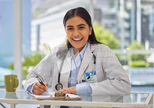 Image of Medical, happy and portrait of doctor in office for consulting, report and paperwork. Medicine, healthcare and checklist with woman writing in hospital for prescription, wellness exam and results