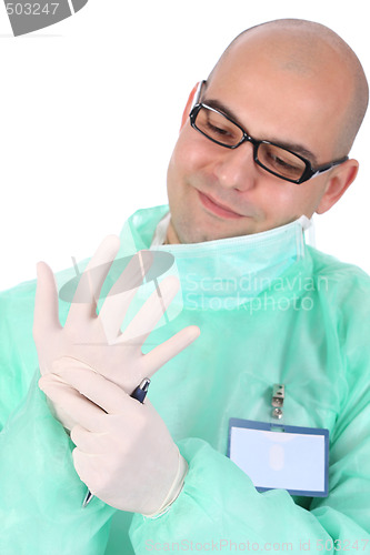 Image of surgeon putting medical gloves on