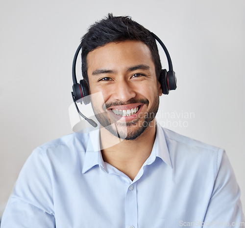 Image of Portrait of man in call center with smile, headset and happy to help at customer service agency or sales desk. Telemarketing, communication or reception, businessman with cheerful face and headphones