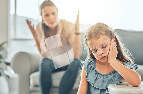 Image of Angry lecture from mother, sad child and problem with discipline in living room, naughty girl behavior in home. Scolding, punishment and frustrated woman, stubborn kid and communication with anger.