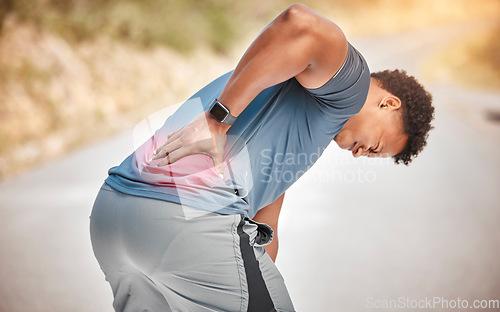 Image of Fitness, back pain and anatomy with a sports man outdoor in nature for cardio or endurance running. Exercise, medical injury or accident with a male athlete holding his body while training for health