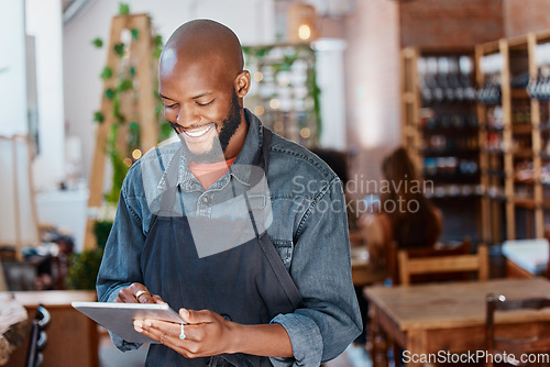 Image of Restaurant, tablet and black man or small business owner, e commerce and online cafe or coffee shop management. Waiter or happy person reading sales on digital technology or internet for his startup