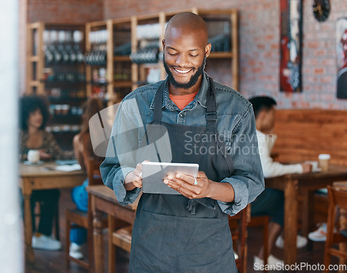 Image of Restaurant, tablet and happy man or small business owner, e commerce and online cafe or coffee shop management. Waiter or african person reading sales on digital technology or internet for startup