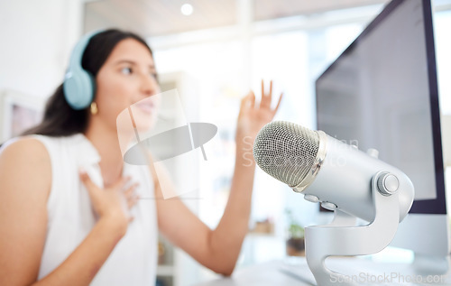 Image of Blur, microphone or woman live streaming a podcast media or online radio on news broadcast network. Influencer host, blurry presenter or girl journalist reporter talking, recording or speaking alone