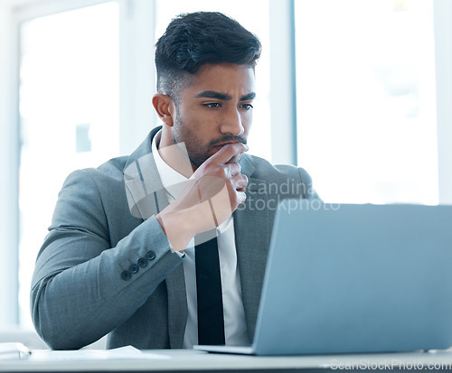 Image of Laptop, corporate and a business man thinking while working on a report in his professional office. Computer, idea and a young male employee contemplating or planning a project in the workplace