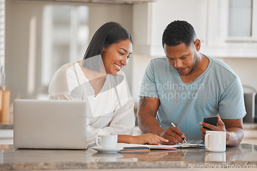 Image of Couple, kitchen and paperwork for budget, finance or smile with laptop, phone and writing notes in home. Man, woman and documents with notebook, mortgage or computer for tax, compliance or investing