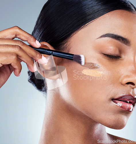 Image of Makeup brush, foundation shade and woman with cosmetics, natural beauty and skincare. Cosmetic, young female model and self care with contour and face product with highlighter for skin glow in studio