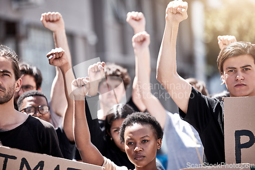 Image of Protest, rally and people fight together for freedom, human rights or equality outdoor in city. Diversity men and women or community with fist, poster and hands for politics, change or social justice