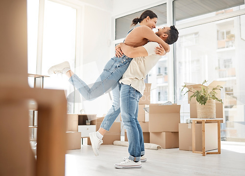 Image of Love, moving and hug with couple in new home for celebration, property and relocation. Excited, happy and real estate with man and woman in living room apartment for investment, rent and homeowner