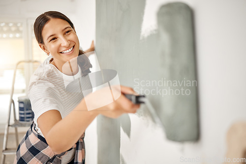 Image of Woman, renovation and painting a home wall in DIY, house project or maintenance or construction, interior design and decoration. Paint, bedroom or remodel space with paintbrush, roller and painter