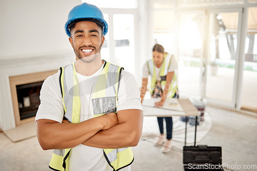 Image of Portrait of man, construction and home renovation with arms crossed, helmet and smile in apartment. Yes, positive mindset and renovations, happy handyman in safety and building project in new house.