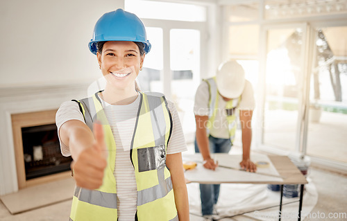 Image of Portrait of woman, construction and home renovation with thumbs up, helmet and smile in apartment. Yes, positive mindset and diy renovations, happy female in safety and building project in new house.