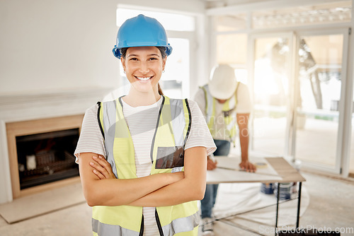 Image of Portrait of woman, construction and home renovation with arms crossed, helmet and smile in apartment. Yes, positive mindset and renovations, happy female in safety and building project in new house.