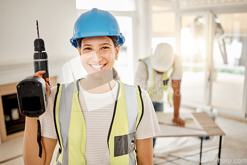 Image of Portrait of woman, construction and home renovation with drill, helmet and smile in apartment. Yes, positive mindset and diy renovations, happy female in safety in building project tools in new house