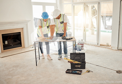 Image of Home renovation, construction and architect team at table for maintenance or architecture. Engineer man and woman talk and planning strategy with handyman tools for teamwork and collaboration project