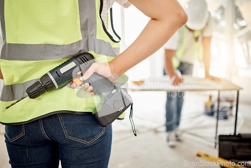 Image of Construction, handyman and drill in hand for maintenance or carpenter work. Back of engineer, constructor or contractor person with electric power tools at building site for home renovation project