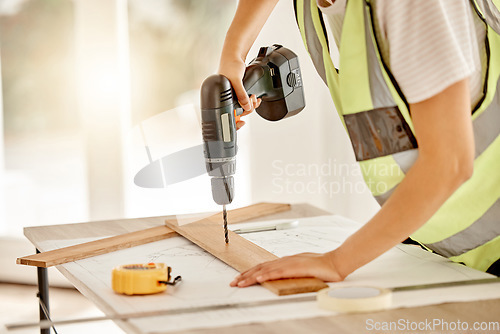 Image of Carpenter, construction and hand with drill and wood for repair, renovation or building project. Hands of contractor, carpenter or technician person with electric power tools or furniture in workshop