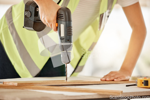 Image of Wood, construction and carpenter hand with a drill for repair, renovation or building. Hands of contractor, carpenter or technician person with electric power tools for furniture project in workshop