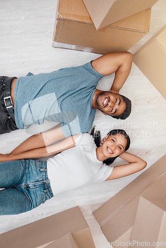 Image of Top view, home and couple with boxes, apartment and excited on the floor, mortgage and relationship. Portrait, man and woman on the ground, cardboard and excited with new house, moving in and growth