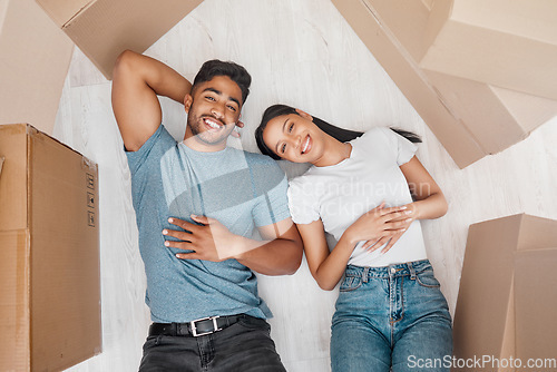 Image of Top view, home and couple with boxes, ground and relationship with property, living room and apartment. Portrait, happy man or woman on the floor, cardboard and property with investment and new house