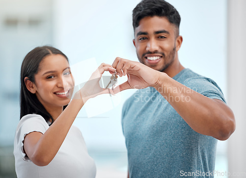 Image of Hand in heart, key and portrait of couple in new home for property, apartment and real estate investment. Relationship, love emoji and man and woman holding keys for relocation, move and moving day