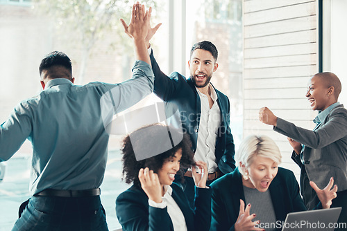 Image of High five, colleagues celebrating and at office of their workplace with a lens flare together. Success or achievement, happy and diverse coworkers support or with celebration at their workspace