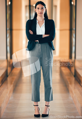 Image of Woman, professional and serious in portrait with arm at the office as leader in entrepreneurship. Female expert, determined and manager at business with arms at an agency for career with confidence.