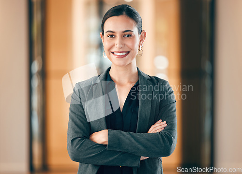 Image of Portrait, smile and arms crossed with a professional business woman in her corporate workplace. Happy, vision and confident with a happy female employee standing in her office wearing a power suit