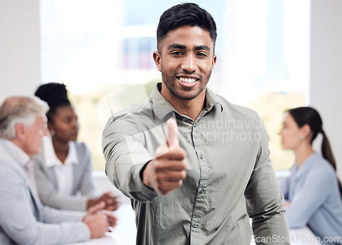 Image of Portrait, smile and a business man thumbs up in the boardroom with his team planning in the background. Leadership, workshop and motivation with a happy young male employee standing in the office