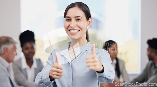 Image of Portrait, happy and a business woman thumbs up in the boardroom with her team planning in the background. Leadership, workshop and smile with a confident young female employee saying thank you