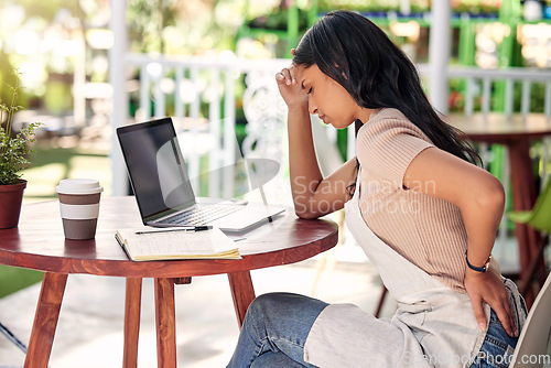 Image of Woman in pain with laptop at garden table, outdoor cafe or plant shop with stress, burnout and back ache. Mental health, small business owner and computer, worry with injury in florist restaurant.