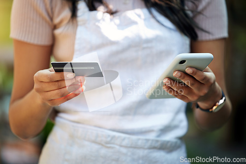 Image of Woman hands, credit card and business owner phone with ecommerce, online shopping and digital payment. Outdoor, banking app and female employee hand with mobile connectivity on web for purchase