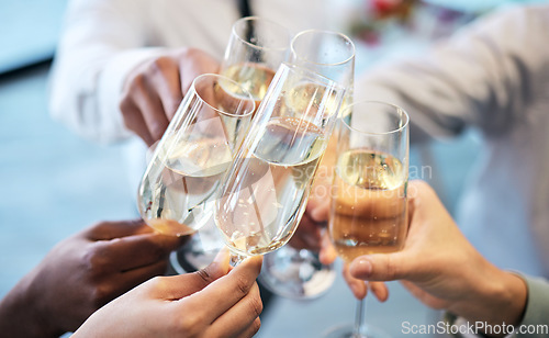 Image of Champagne, toast and business people at an office party in celebration of success together closeup. Hands, glass and cheers with a team or group of colleagues in the workplace to celebrate a goal