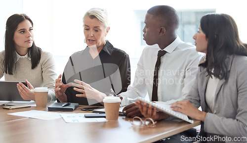 Image of Business people, meeting and manager talking to a team in a corporate office for brainstorming. Diversity men and women at a table for planning, discussion and strategy for growth and development