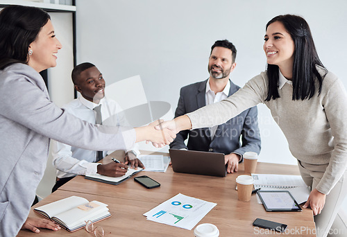 Image of Meeting, welcome and business women shaking hands in the boardroom for a b2b partnership or deal. Thank you, handshake and support with happy female colleagues in agreement while planning at work