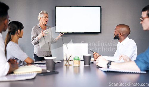 Image of Senior woman, meeting and coaching on mockup in presentation for team strategy or project management at office. Mature female person, coach or CEO mentor training staff on mock up screen at workplace