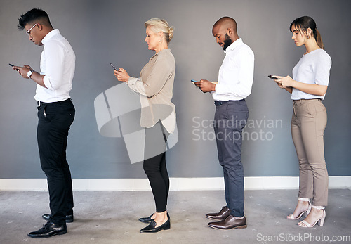 Image of Business people, phone and networking in waiting room or line for interview, hiring or communication. Group of employees standing in row on smartphone for job search, opportunity or social media