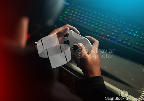 Image of Gaming controller in hands, playing games and online streaming with gamer competition and esports. Video game tech, streamer person in dark room and play tournament with joystick and keyboard