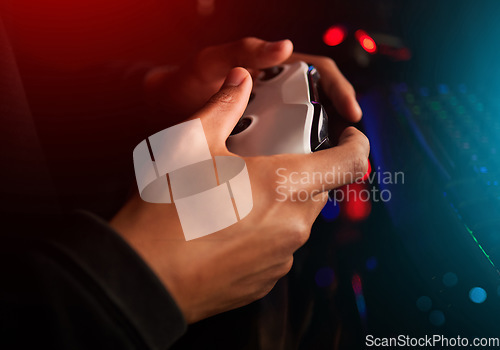 Image of Video game controller in hands, playing games and online streaming with gamer competition and esports. Gaming technology closeup, streamer person in dark room and play tournament with joystick