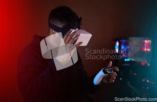 Image of Man in dark room, gaming and VR goggles and controller, online streaming with video games and metaverse. Digital world, male streamer and future technology, games and virtual reality experience