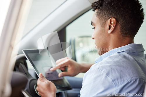 Image of Tablet, navigation and a man driving a car while searching online for directions to a location as a driver. Map, technology and app with a young male sitting in a vehicle for transport or travel